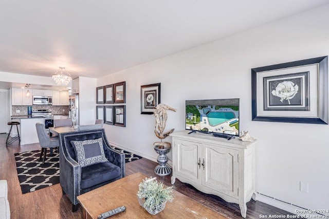 living room with an inviting chandelier and dark hardwood / wood-style floors