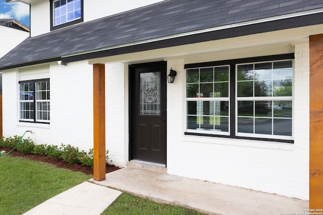 439 Susanwood Dr, San Antonio, TX 78220 - property entrance with brick siding, a porch, and a shingled roof