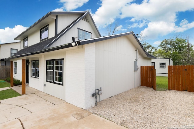 439 Susanwood Dr, San Antonio, TX 78220 - view of side of home with fence, brick siding, and a patio area