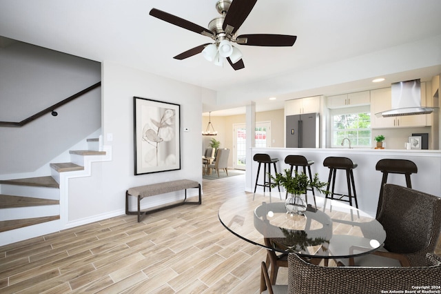 living room with ceiling fan, light hardwood / wood-style flooring, and sink