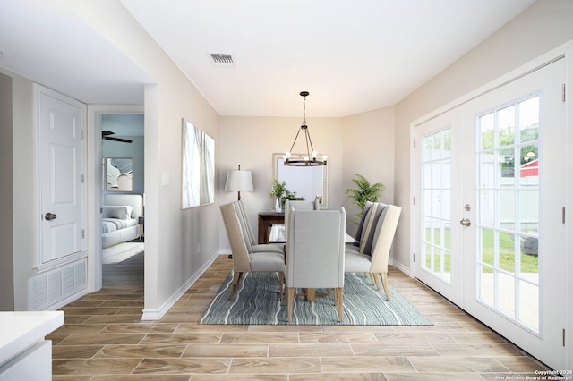 439 Susanwood Dr, San Antonio, TX 78220 - dining area with visible vents, an inviting chandelier, baseboards, and wood finish floors