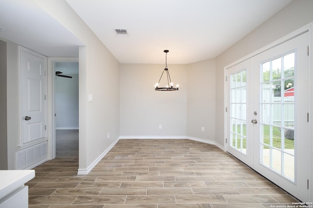 439 Susanwood Dr, San Antonio, TX 78220 - unfurnished dining area featuring wood finish floors, visible vents, french doors, baseboards, and a chandelier