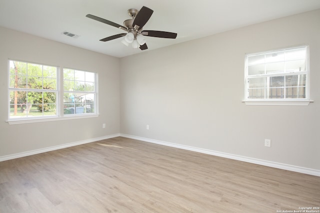 empty room featuring light hardwood / wood-style flooring and ceiling fan