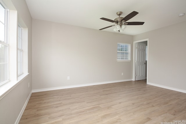 unfurnished room featuring light wood-type flooring and ceiling fan