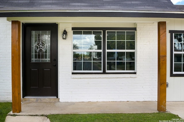 439 Susanwood Dr, San Antonio, TX 78220 - view of exterior entry with brick siding, covered porch, and roof with shingles