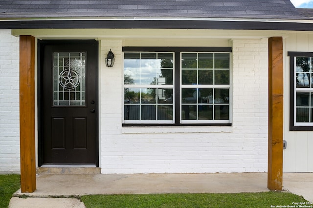 view of exterior entry with a porch