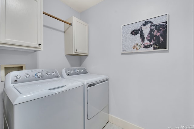 clothes washing area featuring cabinets, independent washer and dryer, and light tile patterned flooring