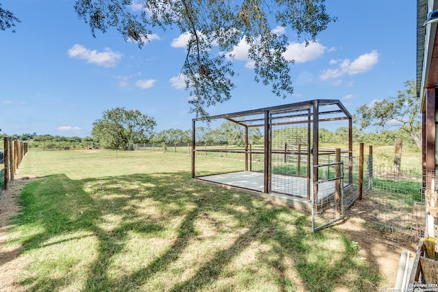 view of yard featuring an outdoor structure and a rural view