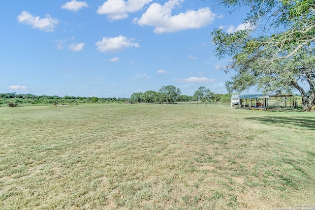 view of yard with a rural view