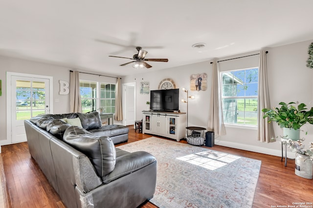 living room featuring ceiling fan, hardwood / wood-style floors, and a wealth of natural light