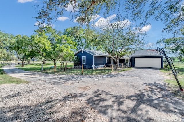 ranch-style house featuring a front yard and a garage