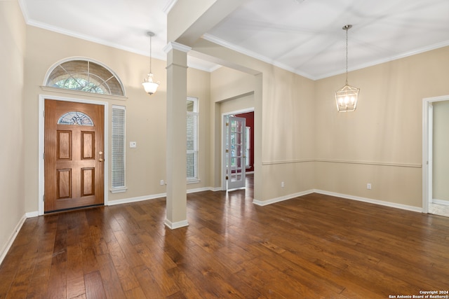 entryway with ornate columns, dark hardwood / wood-style floors, and ornamental molding