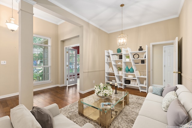 living room with decorative columns, dark wood-type flooring, and crown molding