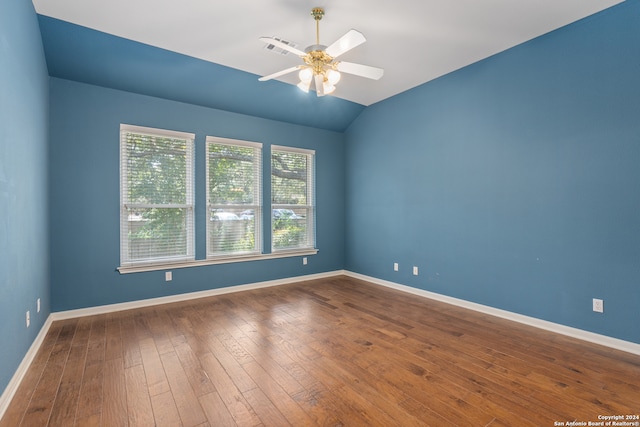 empty room featuring wood-type flooring, lofted ceiling, and ceiling fan