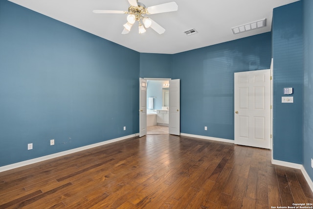 empty room featuring ceiling fan and dark hardwood / wood-style floors