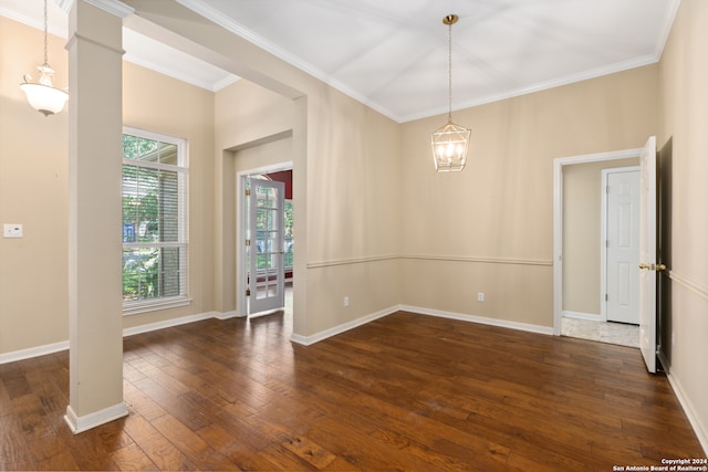 spare room featuring ornamental molding and dark wood-type flooring