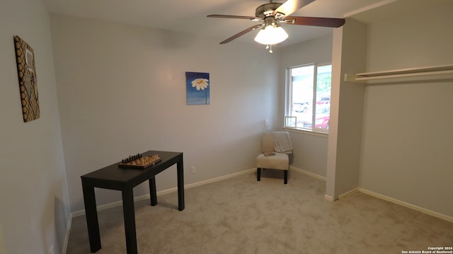 unfurnished room with ceiling fan and light carpet