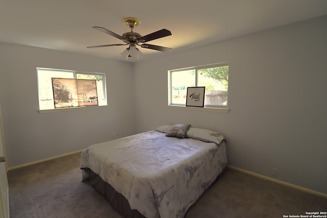 bedroom featuring dark colored carpet and ceiling fan