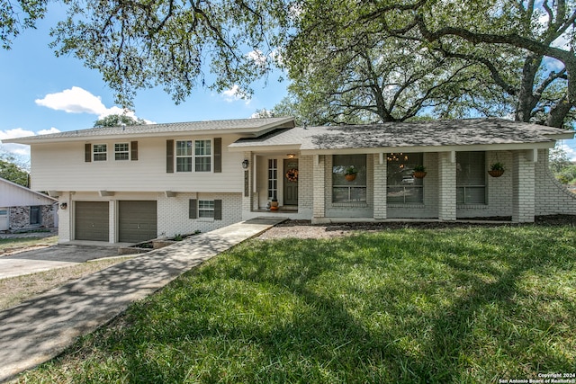 view of front of property featuring a garage and a front lawn