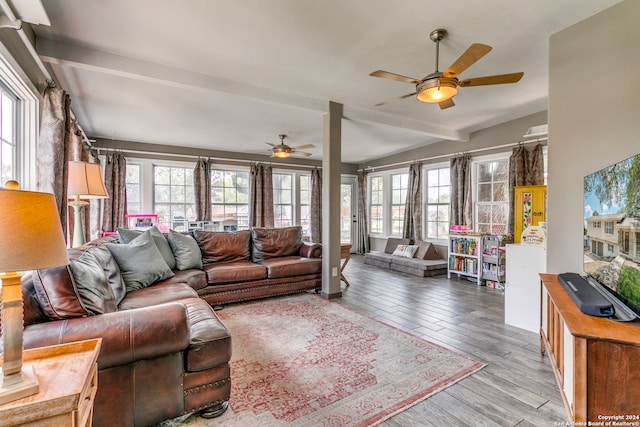 living room featuring ceiling fan, hardwood / wood-style flooring, and lofted ceiling with beams