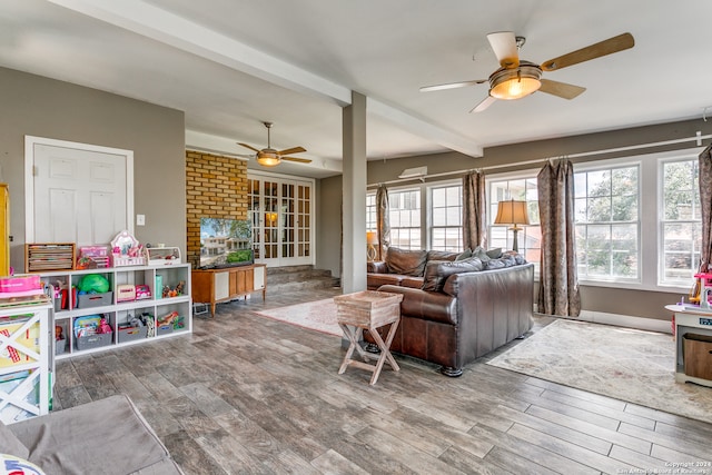 living room with ceiling fan, beamed ceiling, and hardwood / wood-style floors