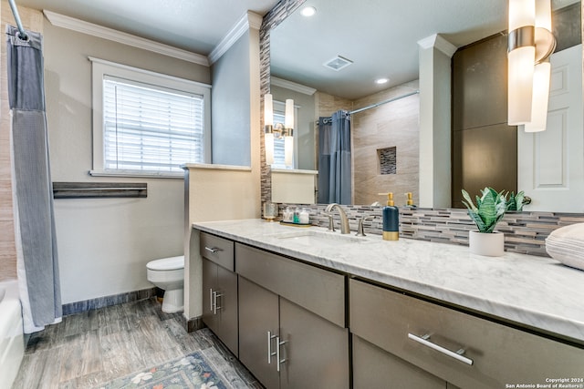 full bathroom with backsplash, hardwood / wood-style floors, shower / tub combo with curtain, vanity, and toilet