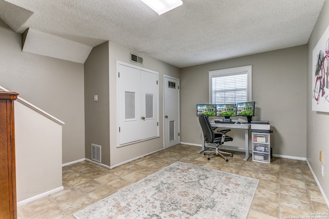 home office featuring a textured ceiling