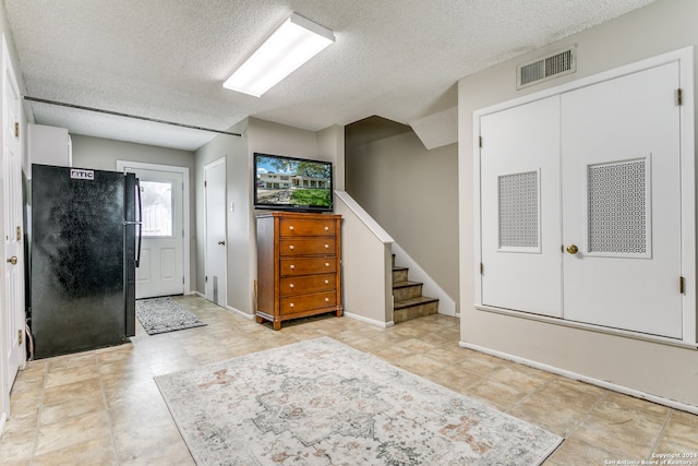 entrance foyer with a textured ceiling