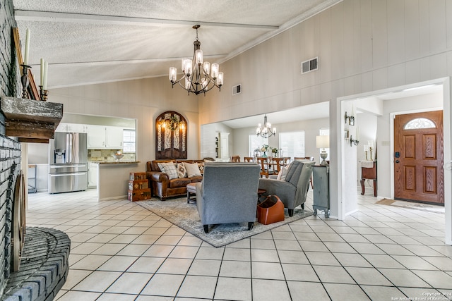 living room featuring light tile patterned floors, a textured ceiling, crown molding, and a notable chandelier