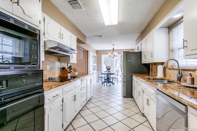 kitchen featuring white cabinetry, tasteful backsplash, black appliances, an inviting chandelier, and decorative light fixtures