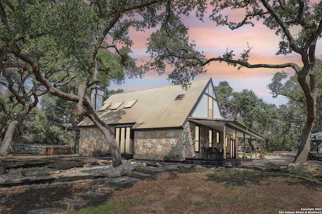 property exterior at dusk with covered porch