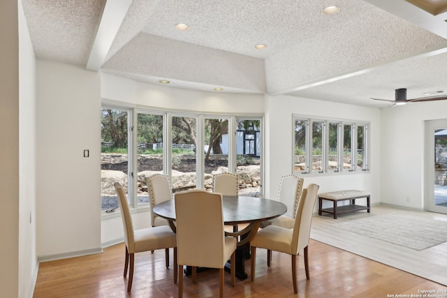 dining area with wood-type flooring, ceiling fan, and a textured ceiling