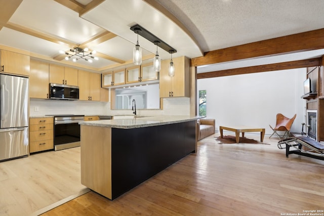 kitchen with light brown cabinets, light hardwood / wood-style floors, stainless steel appliances, and kitchen peninsula