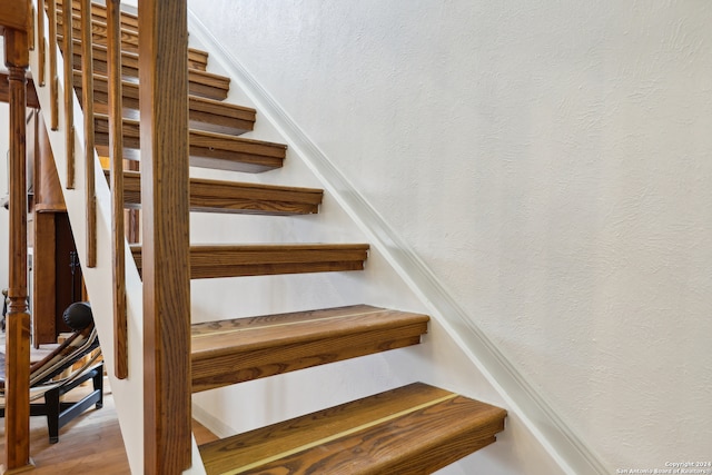 stairs featuring wood-type flooring