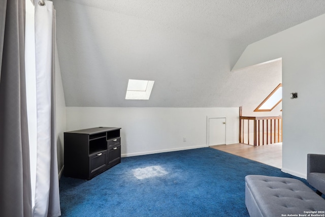 bonus room featuring carpet floors, a textured ceiling, and lofted ceiling with skylight