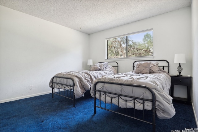 carpeted bedroom featuring a textured ceiling