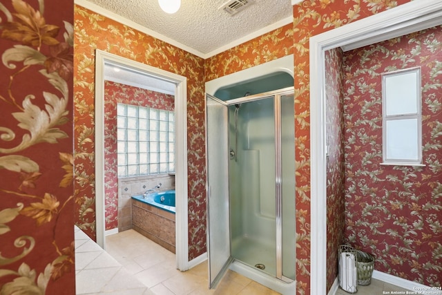 bathroom featuring ornamental molding, a textured ceiling, tile patterned floors, and separate shower and tub