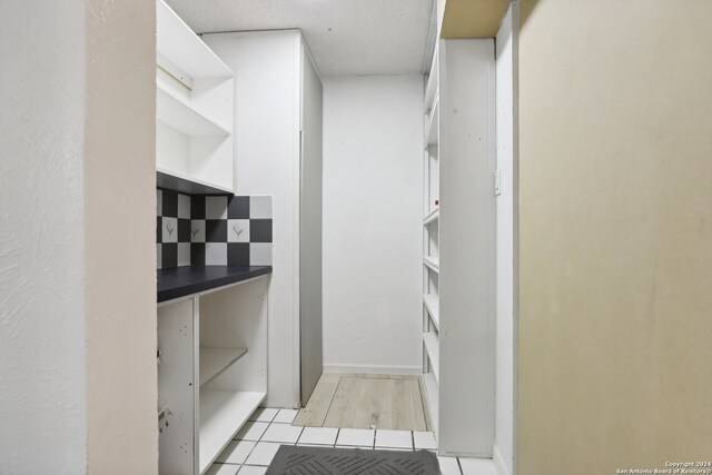 spacious closet with light tile patterned floors