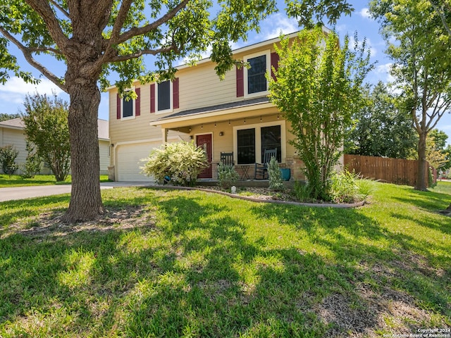 view of front of house with a garage, a porch, and a front lawn