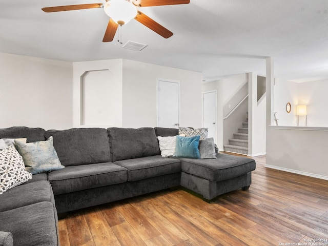 living room featuring ceiling fan and hardwood / wood-style flooring