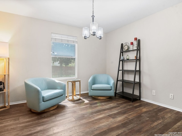 sitting room featuring a chandelier and dark hardwood / wood-style flooring