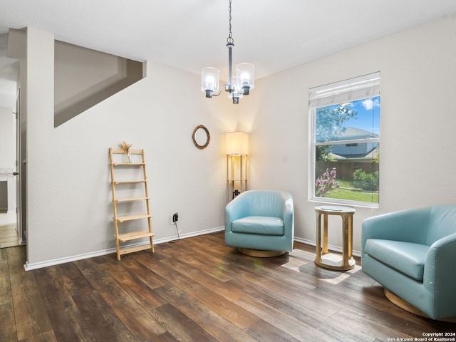 living area with a notable chandelier and dark hardwood / wood-style floors