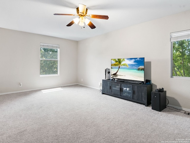 living room featuring carpet and ceiling fan