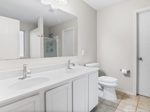 bathroom featuring tile patterned floors, walk in shower, vanity, and toilet