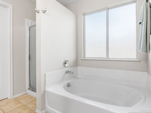 bathroom with separate shower and tub, tile patterned flooring, and a wealth of natural light