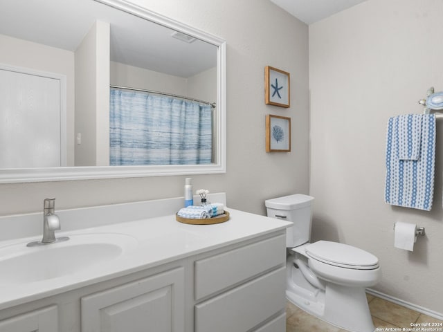 bathroom featuring vanity, tile patterned flooring, and toilet