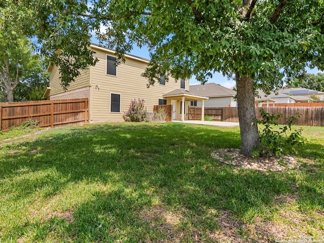 rear view of property with a patio and a yard