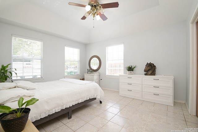 tiled bedroom featuring ceiling fan and multiple windows