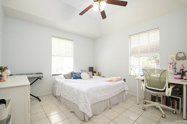 bedroom with ceiling fan, light tile patterned flooring, and multiple windows