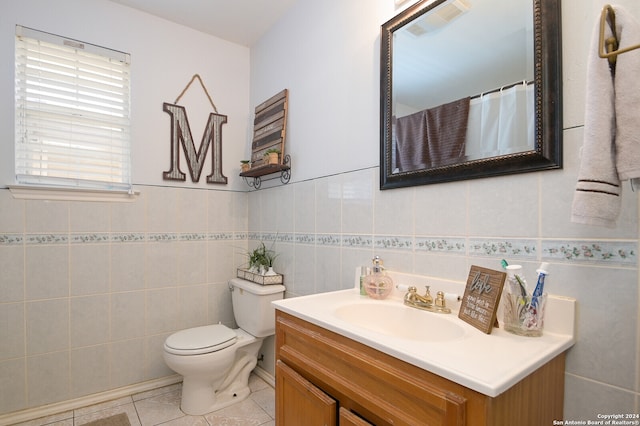 bathroom with tile walls, vanity, and toilet